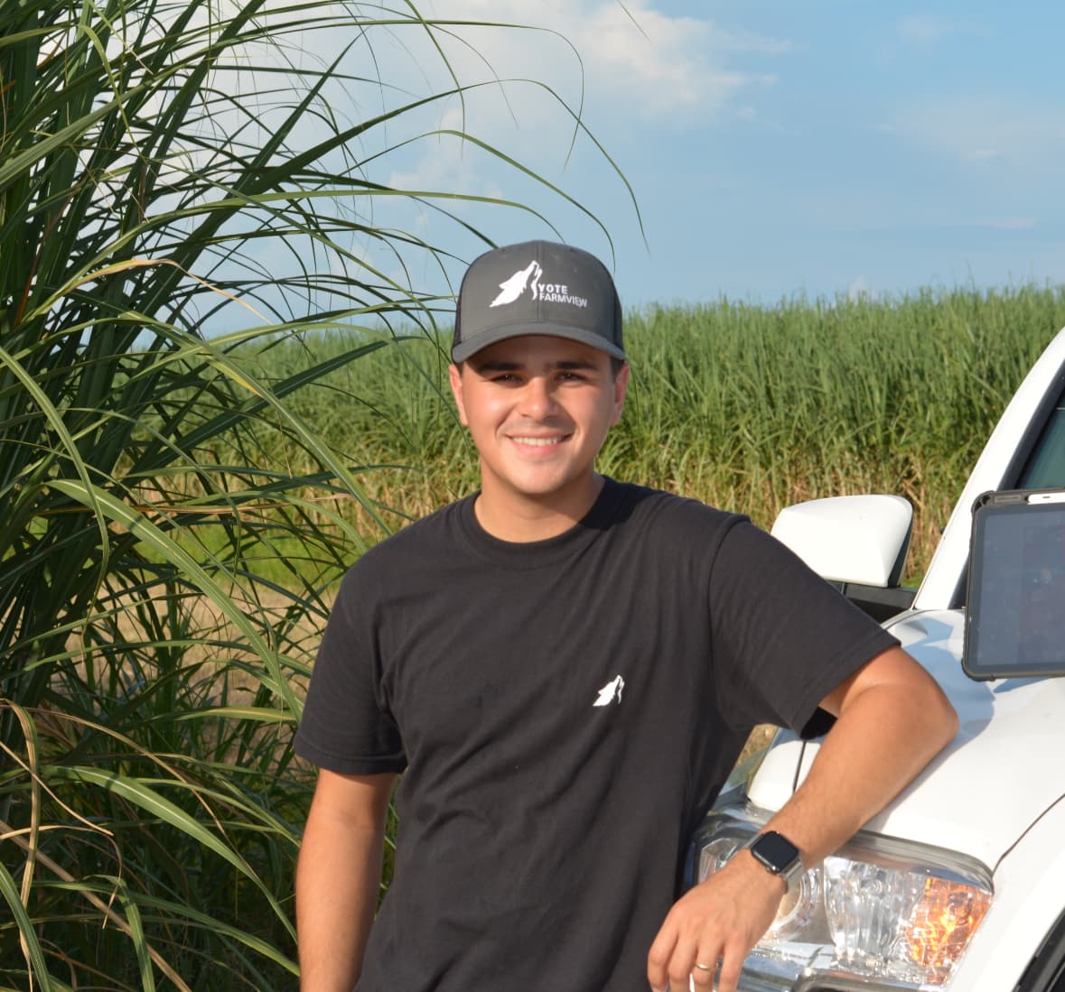 Caio Phillipi — Founder of Yote Farmview — standing in a sugarcane field